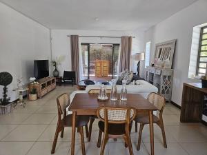 a living room with a dining table and a bed at Private Secured 4 Bedroom Villa in Grand-Baie