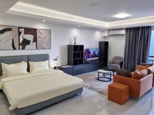 a bedroom with a large bed and a living room at Studio Apartment in Kigali in Kigali