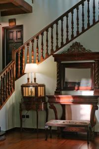 a staircase with a table and a mirror and a piano at Rigat Park & Spa Hotel - Adults Recommended in Lloret de Mar