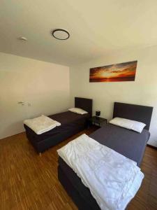 a room with two beds in a room at Sunset Dreams Apartment in Bühl