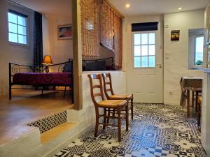 a room with two chairs and a table and a door at Studio 2A in Ucciani