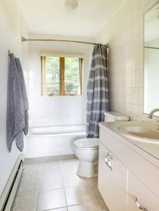 a white bathroom with a toilet and a sink at Campbell Estates in Franklin