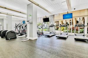 a gym with treadmills and cardio equipment in a building at Oceanview Beachfront Condo on Tides Resort in Hollywood
