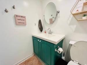 a bathroom with a green sink and a mirror at Oceanview Beachfront Condo on Tides Resort in Hollywood +10 photos