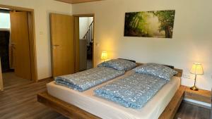 a bed in a room with two pillows on it at Greenhaus in Feldberg