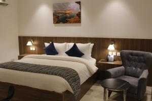 A bed or beds in a room at Duqm Express Hotel