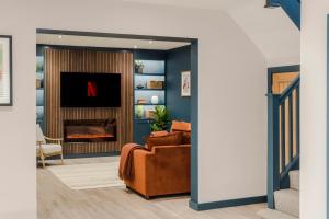 a living room with a couch and a fireplace at Barley Vale - Your Apartment in Bristol