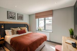 a bedroom with a bed and a window at Barley Vale - Your Apartment in Bristol
