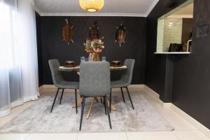 a dining room with a table and chairs at Sapphire Guesthouse in Pinetown