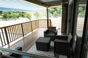a screened in porch with chairs and a table at Sapphire Guesthouse in Pinetown