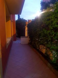 a walkway leading to a building with the sun shining at Solenzara tre passi dal mare in Roquebrune-Cap-Martin