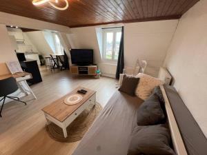 a living room with a couch and a coffee table at Soft Dream- Hyper Centre Dunkerque et Proche Plage 15m in Dunkerque