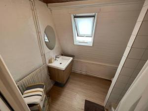 a small bathroom with a sink and a mirror at Soft Dream- Hyper Centre Dunkerque et Proche Plage 15m in Dunkerque +7 photos