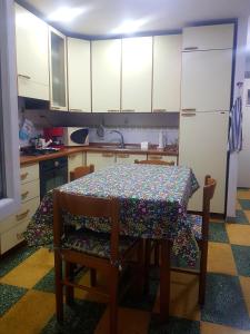 a kitchen with a table with a table cloth on it at Solenzara tre passi dal mare in Roquebrune-Cap-Martin