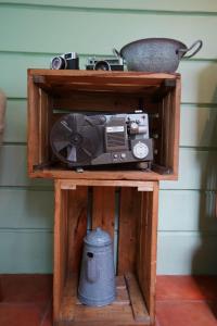 a wooden shelf with a radio and a pot on it at BELVA huis in Bogor