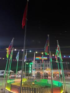 a building with flags in front of it at night at Grand Atakum Boutıque Hotel in Mahmutlu