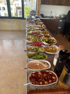 a buffet line of plates of food on a table at Rustic Caves Hotel in Göreme
