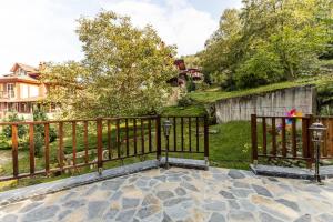 a wooden fence on a patio with a yard at Sleek Villa with Backyard and Sapanca Lake View in Sapanca