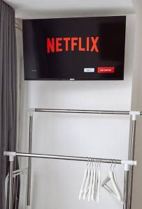 a netflix sign on the wall of a bathroom at 2 bed London Studio Flat, Fully Equipped. in Croydon