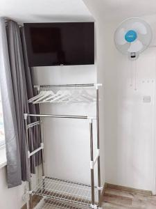 a shelf with a tv on a wall at 2 bed London Studio Flat, Fully Equipped. in Croydon