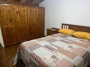 a bedroom with a bed with a quilt on it at Depto céntrico General Alvear in General Alvear