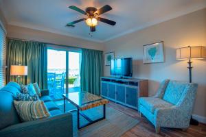 a living room with a couch and a tv at Villas at Hawks Cay Resort in Duck Key