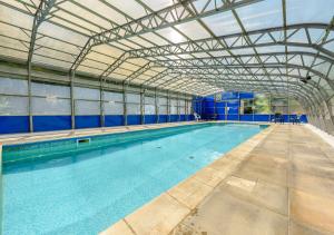 a large indoor swimming pool with a large pool at Tracy - Upcott House in Barnstaple