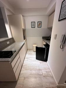 布宜諾斯艾利斯的住宿－STUDIO BARRACAS，一间小厨房,配有白色橱柜和瓷砖地板