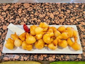 a plate of food with tater tots on a table at Hotel Elena in Veliko Tŭrnovo