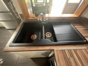 a kitchen sink with a faucet in a kitchen at Avoca Lodge in Lisburn