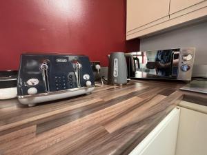 a kitchen counter with a toaster and a toaster at Avoca Lodge in Lisburn