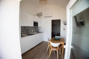a kitchen and dining room with a table and chairs at 1820 Marè in Molfetta