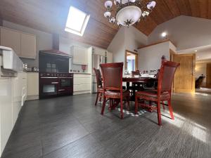 a kitchen with a dining room table and chairs at Avoca Lodge in Lisburn