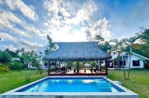 a villa with a swimming pool and a gazebo at Lope Lope Beach Bungalows in Luganville