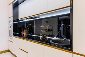 a bathroom with a sink and a mirror at Golden Greens Studio - Luxury Design & Self Check-in in Braşov +28 photos