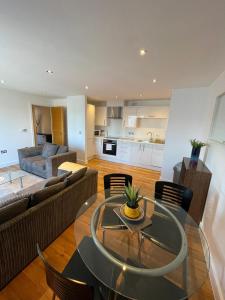 a living room with a glass table and a couch at Blue Sky Apartments@ Abbots Yard, Guildford in Guildford
