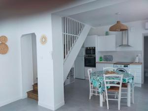 uma cozinha e sala de jantar com uma mesa e uma escada em Charmante maison entièrement rénovée cœur de ville em Blois