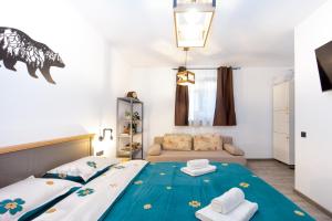 una camera da letto con un letto e un divano di The Bear's Den in old city centre a Braşov