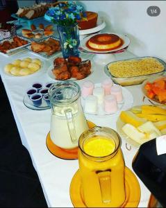 a table with many different types of food on it at Pousada da Jaqueira - EPP in Rio das Ostras