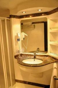 a bathroom with a sink and a mirror at مركب ريفر River Boat in Cairo