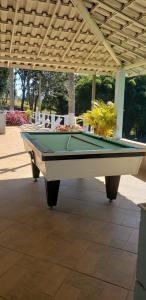 a pool table sitting under a pavilion at Pousada Oásis 2 in Fama