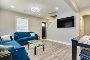 a living room with blue couches and a flat screen tv at Updated Home - Walk to Salisbury University! in Salisbury