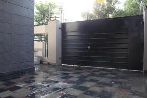 a black garage door with a checkered tile floor at Vacation Villa in Lahore