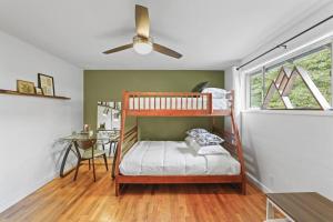a bedroom with two bunk beds and a table at The Jasmine House in Eugene
