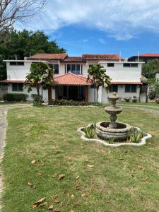 a yard with a fountain in front of a house at Coronado Beachfront tropical home! in Playa Coronado