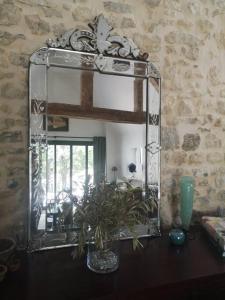 ein Spiegel auf einem Holztisch in der Unterkunft Au cœur de Mortagne, un balcon sur le Perche in Mortagne-au-Perche