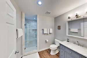a bathroom with a toilet and a glass shower at Copano Ridge Dream A in Rockport