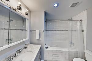 a white bathroom with a tub and a sink at Copano Ridge Dream A in Rockport