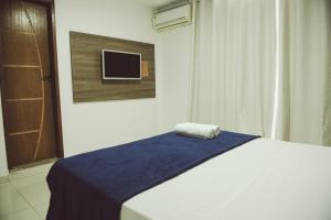 Ένα ή περισσότερα κρεβάτια σε δωμάτιο στο Pousada Xerxes
