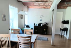 a dining room and living room with a table and chairs at Bøelgaarden in Gørding